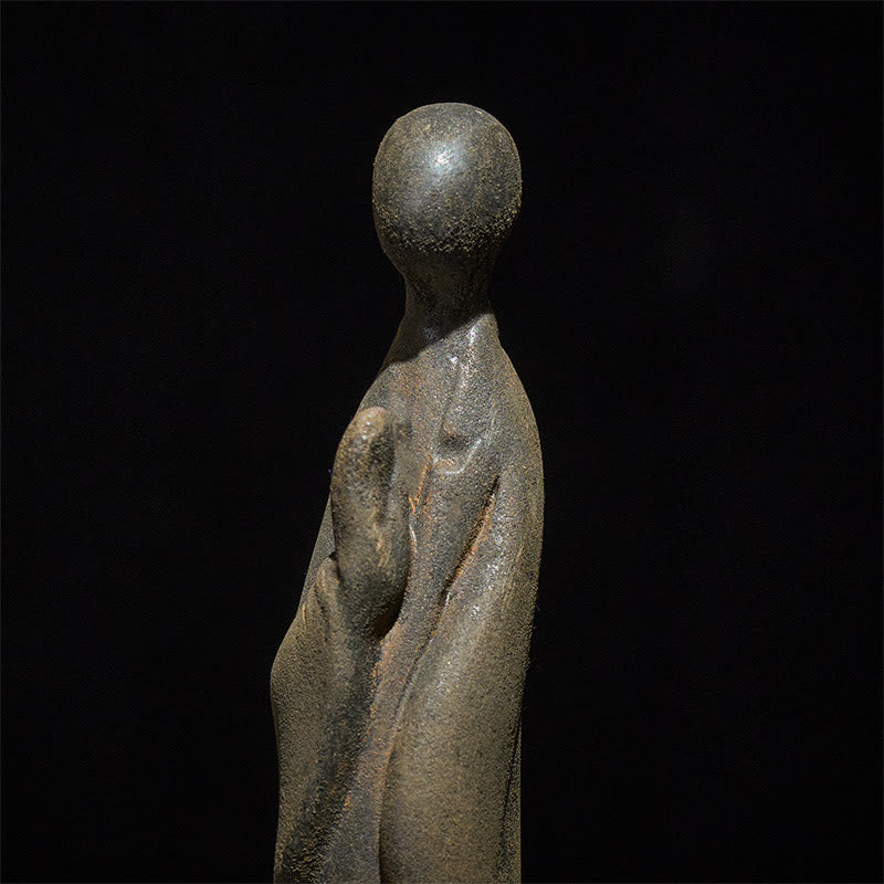 Iron Powder Formless Buddha Statue – closeup of iron powder grain and robe fold detail, macro