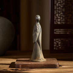 Iron Powder Formless Buddha Statue – front view on wooden base, warm interior light, zen decor