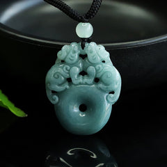 Double Pixiu Jade Peace Buckle String Necklace – pendant hanging by dark bowl, green leaf accent