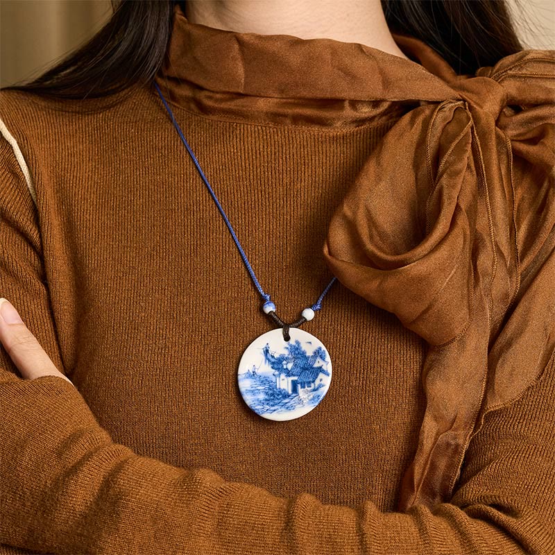 Ceramic Peony & Lotus Pendant – Landscape porcelain pendant worn with brown turtleneck, on-model necklace