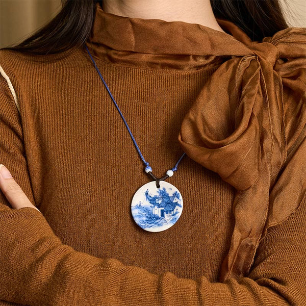 Ceramic Peony & Lotus Pendant – Landscape porcelain pendant worn with brown turtleneck, on-model necklace