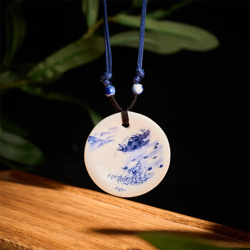 Ceramic Peony & Lotus Pendant – Fishing boat scene on blue-white disc with dark backdrop, porcelain necklace