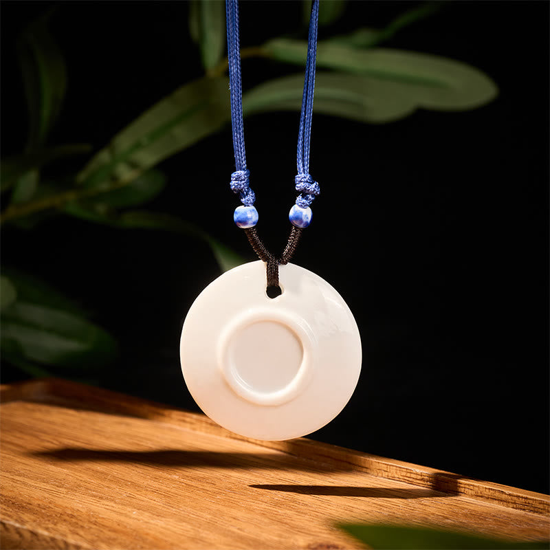 Ceramic Peony & Lotus Pendant – Recessed white disc pendant on wood grain with blue cord, ceramic pendant