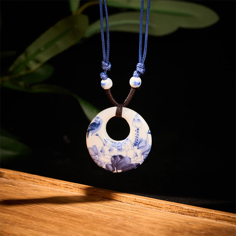 Ceramic Peony & Lotus Pendant – Blue-white porcelain bi disc with bird and lotus on black, porcelain necklace