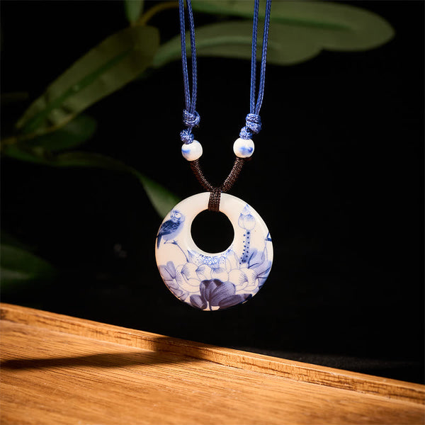 Ceramic Peony & Lotus Pendant – Blue-white porcelain bi disc with bird and lotus on black, porcelain necklace