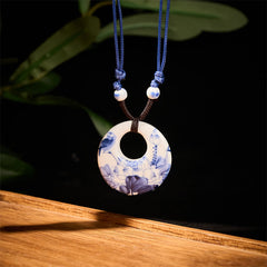 Ceramic Peony & Lotus Pendant – Blue-white porcelain bi disc with bird and lotus on black, porcelain necklace