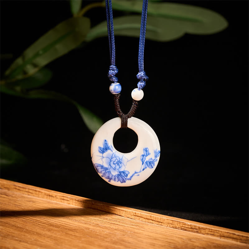 Ceramic Peony & Lotus Pendant – Front view of floral bi disc against black backdrop, ceramic pendant