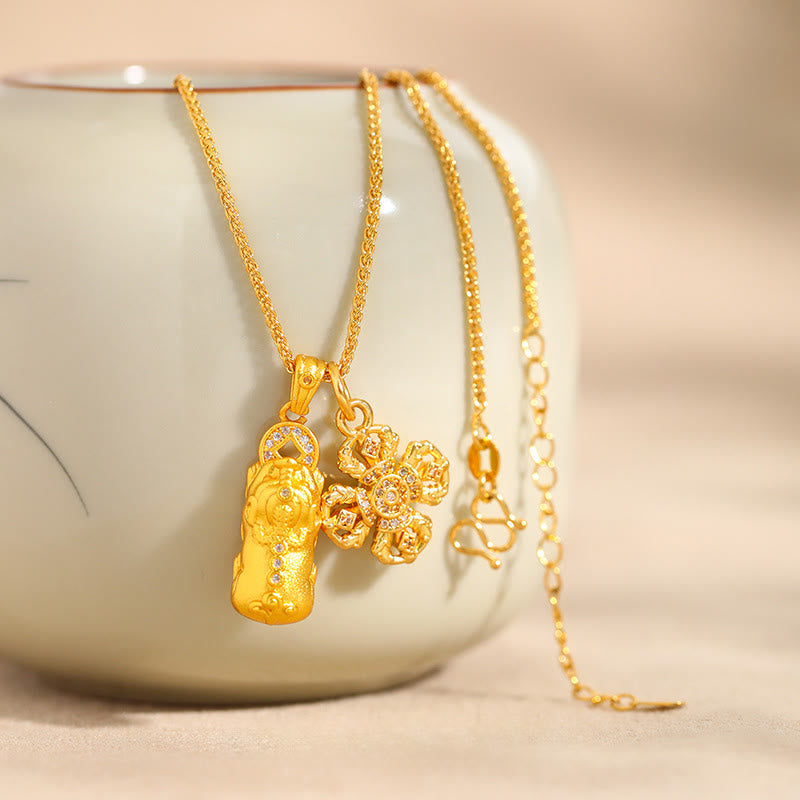 24K Gold Plated Pixiu Cross Dorje Vajra Necklace – draped over ceramic vase, elegant gold chain