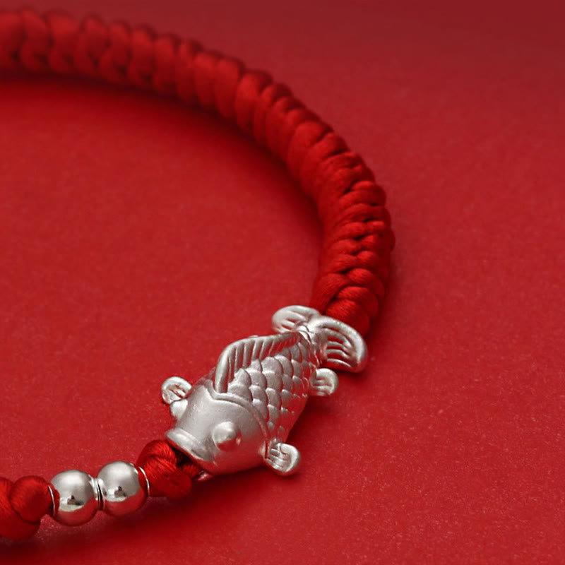 999 Silver Koi Fish Red String Bracelet – close-up of silver koi fish charm with detailed scales on red braided cord