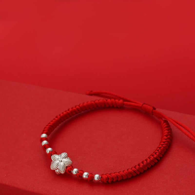 Sterling Silver Lotus Red String Luck Bracelet – elevated side view of five-petal flower charm on red cord, auspicious