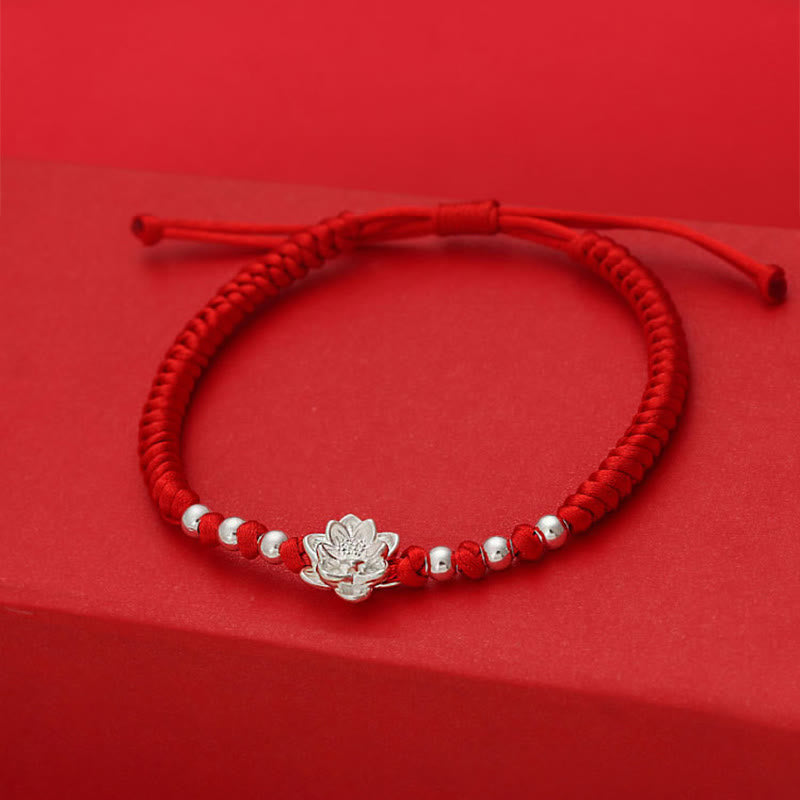 Sterling Silver Lotus Red String Luck Bracelet – top-down angle of braided red cord with centered silver lotus, protective