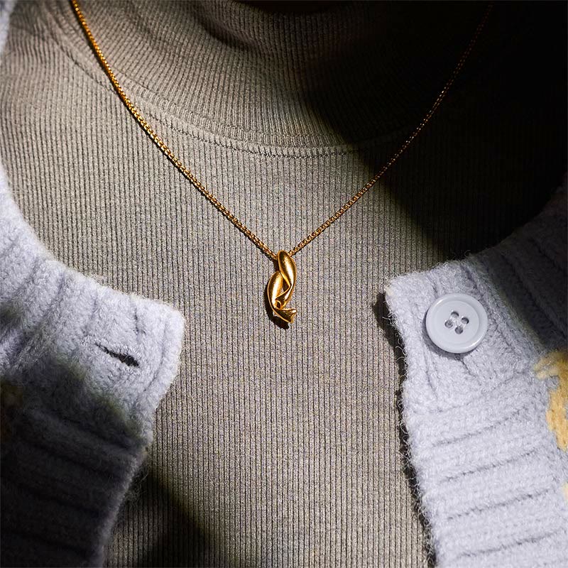 Double Koi Fish Gold Necklace Pendant – pendant worn over gray knit sweater, 24K gold plated wealth necklace