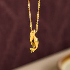 Double Koi Fish Gold Necklace Pendant – gold koi pendant against deep burgundy bg, prosperity necklace