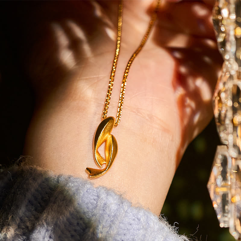 Double Koi Fish Gold Necklace Pendant – gold pendant close-up showing interlocking fish detail, brass jewelry