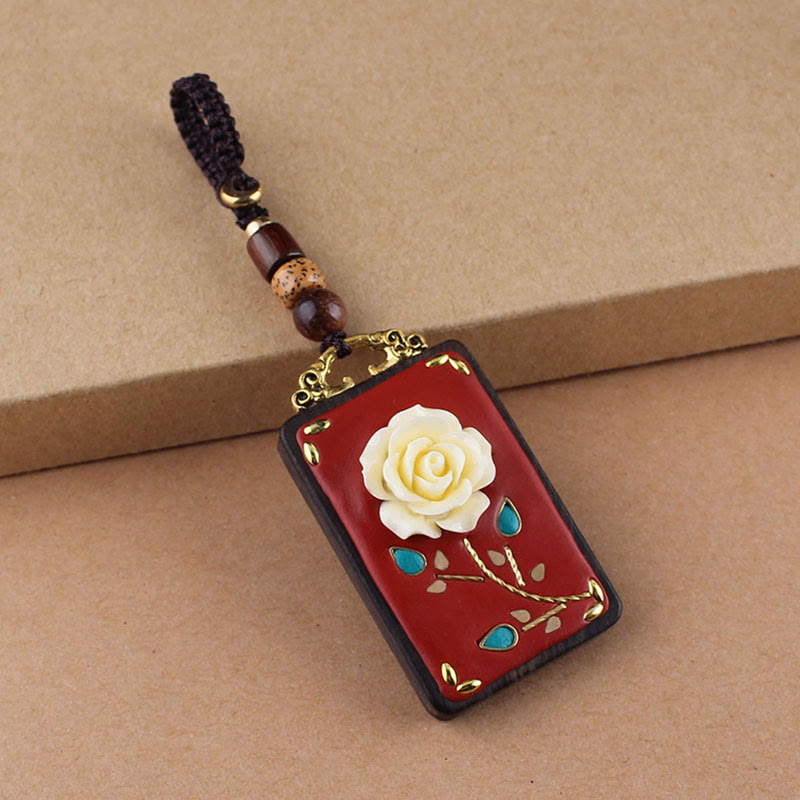 Ebony Koi Fish Fu Character Keychain – single red lacquer rose pendant with gold stem and turquoise inlay on kraft paper