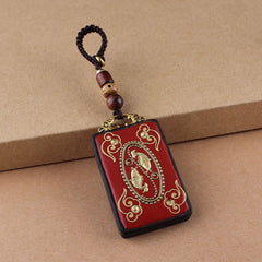 Ebony Koi Fish Fu Character Keychain – red lacquer koi fish pendant with gold cloud motifs and beaded cord on kraft paper