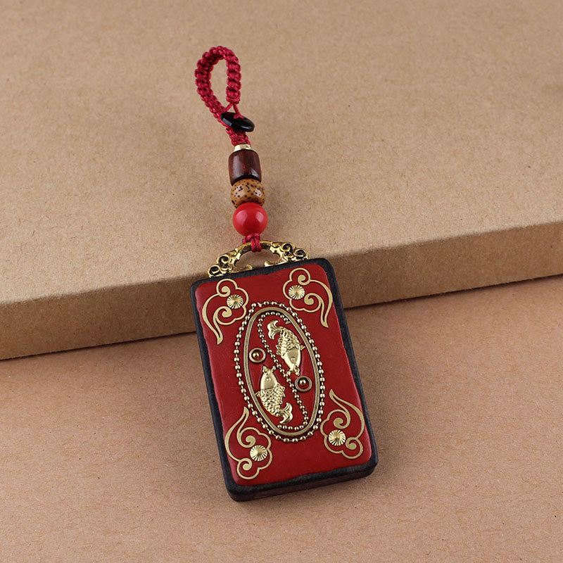 Ebony Koi Fish Fu Character Keychain – red lacquer koi fish pendant with gold cloud scrolls and beaded burgundy cord close-up