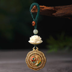 Bodhi Seed Lotus Jade Key Chain - Gold phoenix medallion keychain hanging from wooden branch, forest backdrop