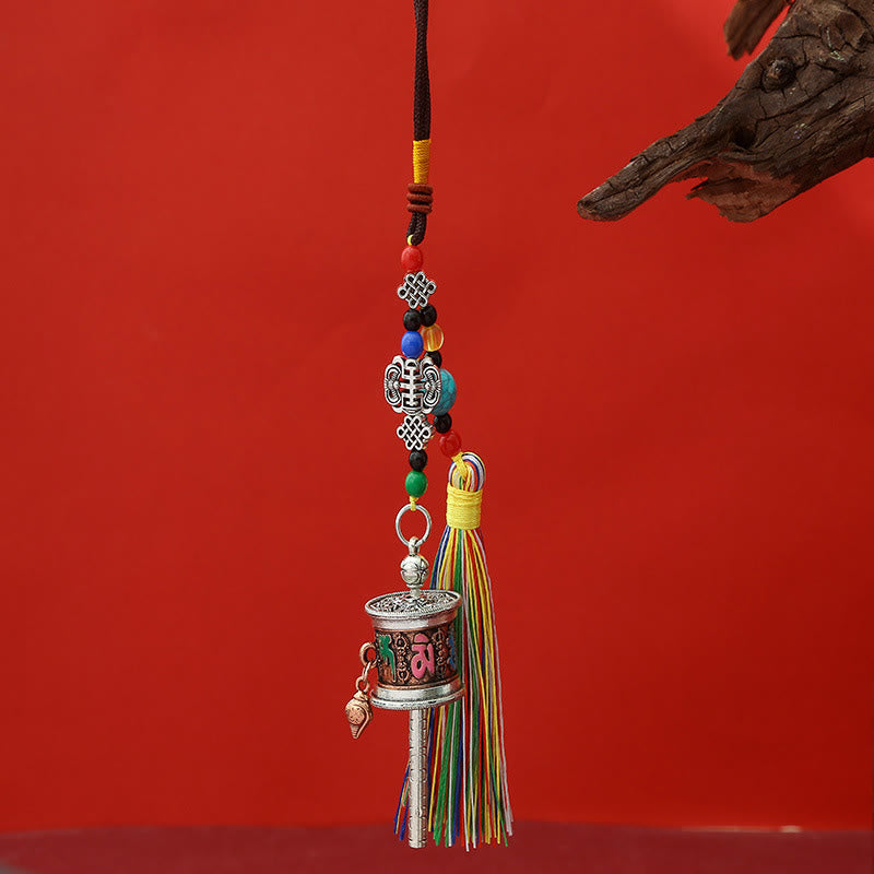 Tibetan Prayer Wheel with pink Om symbol, green accents, silk tassel, spiritual keychain