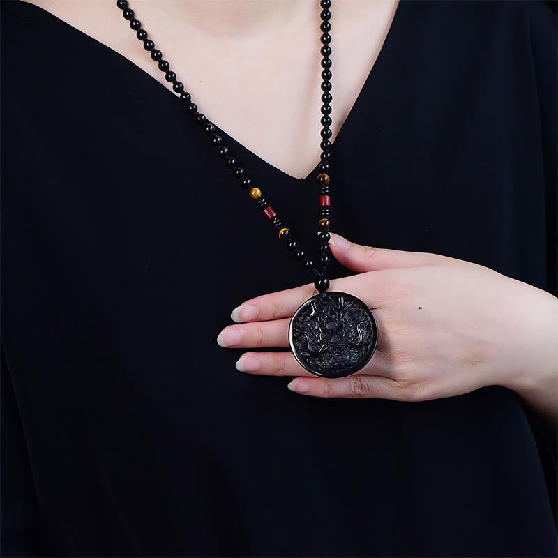 Black Obsidian Dragon Necklace - worn with hand holding carved medallion, beaded cord detail, Grounding