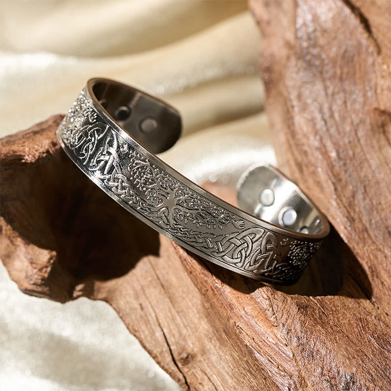 Tree of Life Copper Cuff Bracelet – warm light on driftwood showing embossed design, wellness jewelry