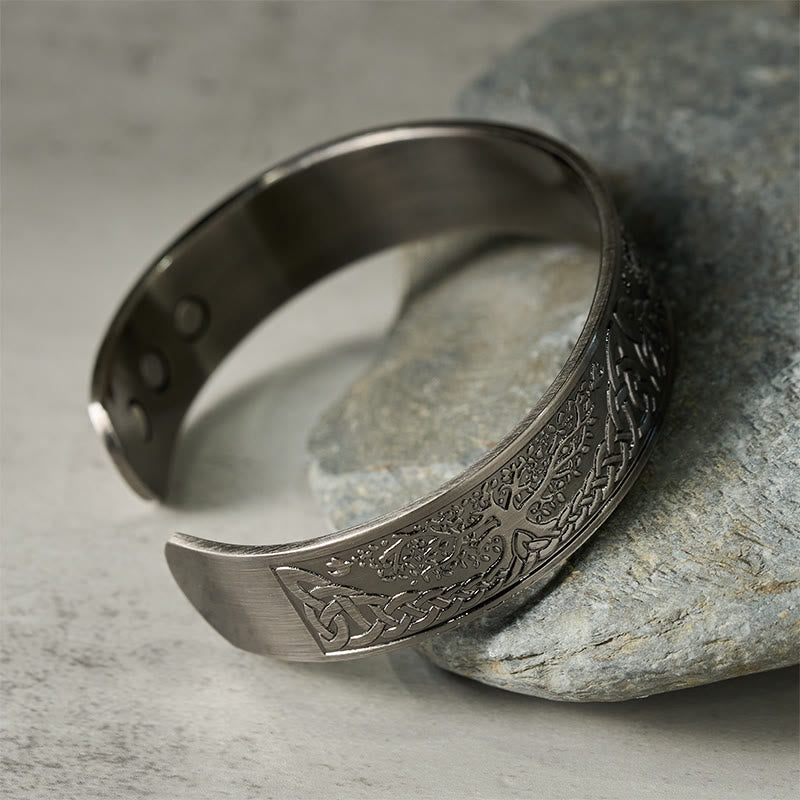 Tree of Life Copper Cuff Bracelet – angled view on stone prop highlighting tree pattern, magnetic bracelet