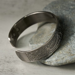 Tree of Life Copper Cuff Bracelet – angled view on stone prop highlighting tree pattern, magnetic bracelet