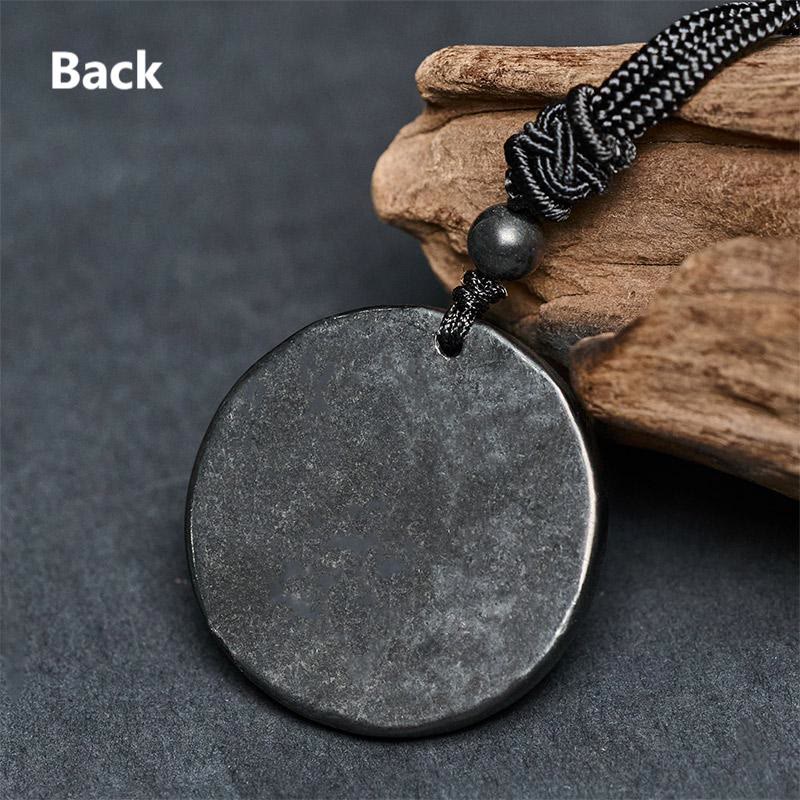 Shungite Stone Yin Yang Bagua Necklace - flat lay on gray, taoist jewelry