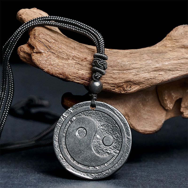 Natural Shungite Carved Yin Yang Pendant - angled detail on driftwood, shungite jewelry