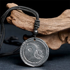 Natural Shungite Carved Yin Yang Pendant - angled detail on driftwood, shungite jewelry