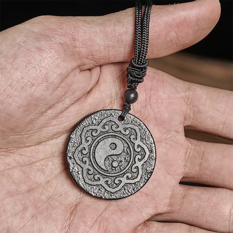 Shungite Yin Yang Pendant – held in palm showing scale, shungite healing pendant