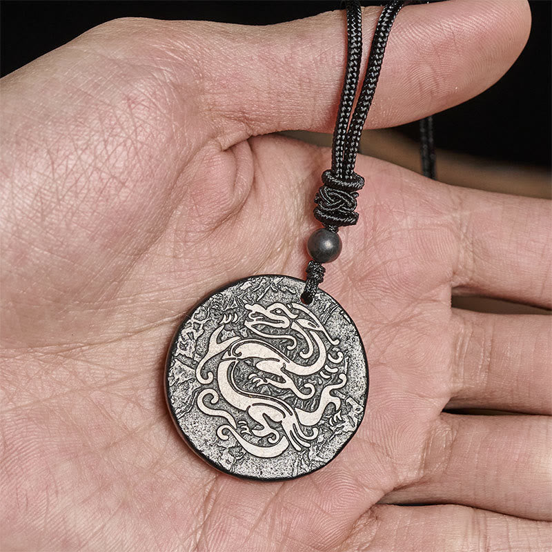 Shungite Dragon Necklace - hand holding silver and black dragon medallion, braided cord, Confidence