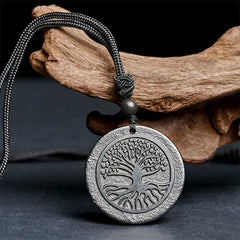 Tree of Life Shungite Stone Necklace – angled close-up on driftwood prop, emf protection pendant