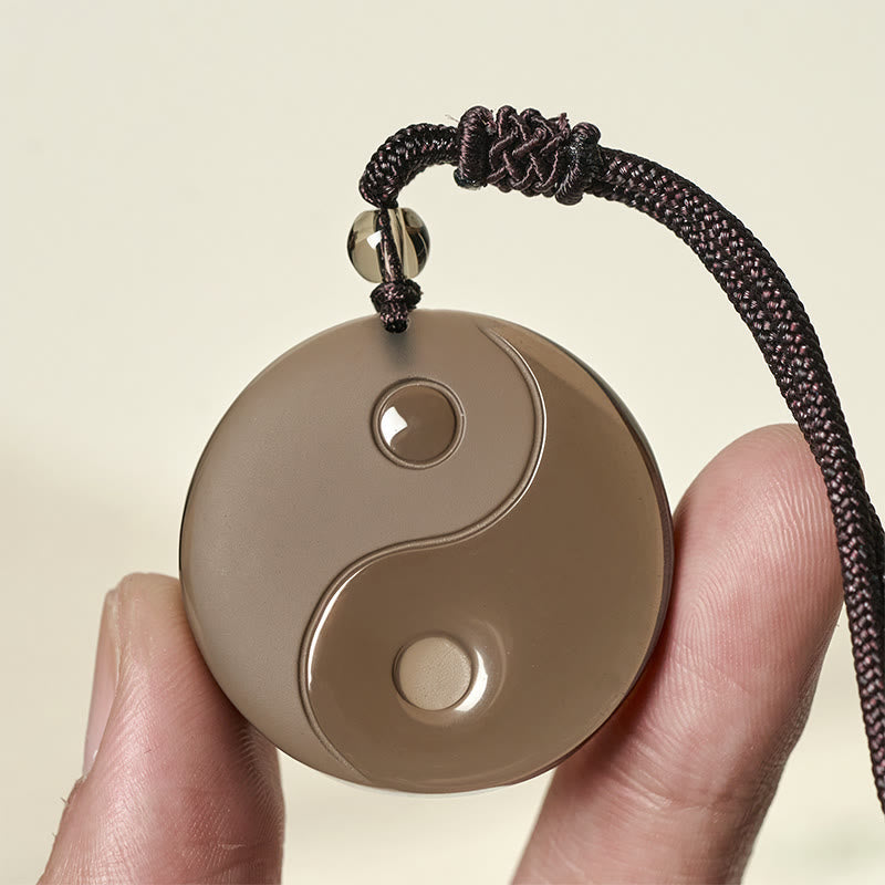 Ice Obsidian Yin Yang Pendant – close-up hand-held detail, polished obsidian jewelry