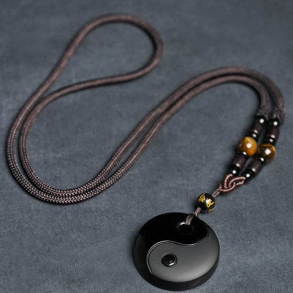 Full Yin Yang Obsidian Necklace flat lay, tiger's eye beads, macrame cord, spiritual jewelry