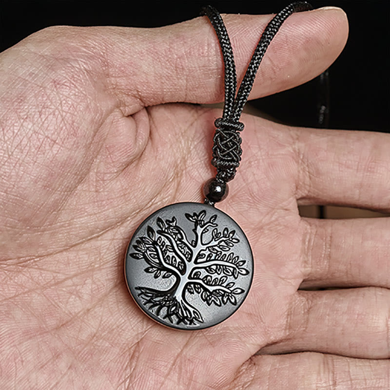 Tree of Life Black Obsidian Necklace – held in palm showing size and tree engraving, black obsidian pendant