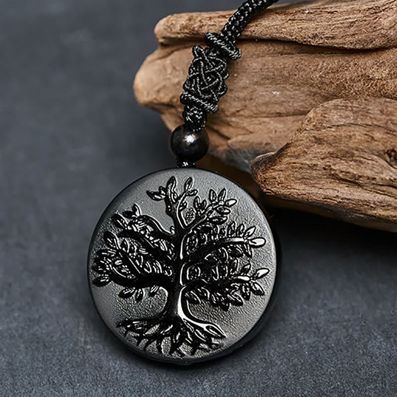 Tree of Life Black Obsidian Necklace – close-up angled view on wooden prop, transformation pendant