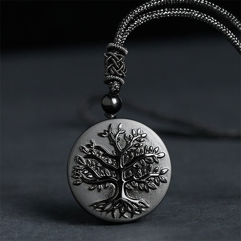 Tree of Life Black Obsidian Necklace – round pendant with engraved tree detail on gray cord, spiritual jewelry