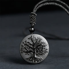 Tree of Life Black Obsidian Necklace – round pendant with engraved tree detail on gray cord, spiritual jewelry