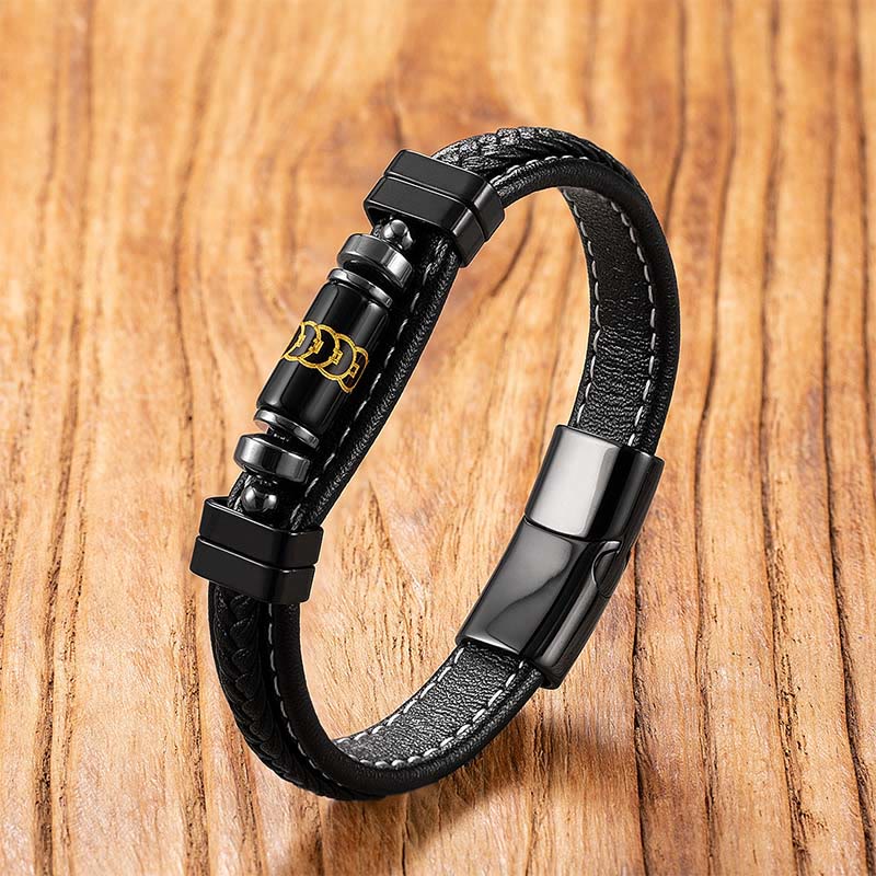 Black Onyx Om Mani Padme Hum Dragon Bracelet – braided leather with gold mantra bead on wood surface, Wisdom