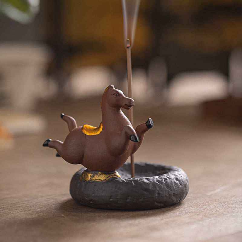 Year of the Horse Incense Burner – Terracotta horse with smoke curling up on natural wood setting