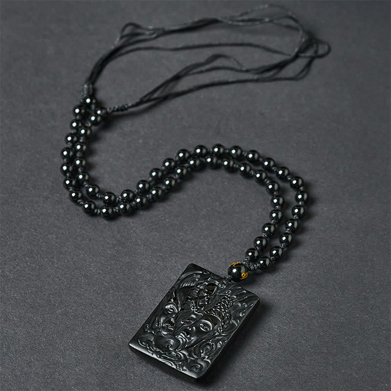 Half Demon Half Buddha Black Obsidian Relief Pendant Necklace – pendant held in hand for scale, black obsidian jewelry