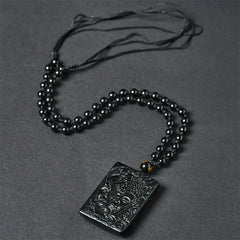 Half Demon Half Buddha Black Obsidian Relief Pendant Necklace – pendant held in hand for scale, black obsidian jewelry