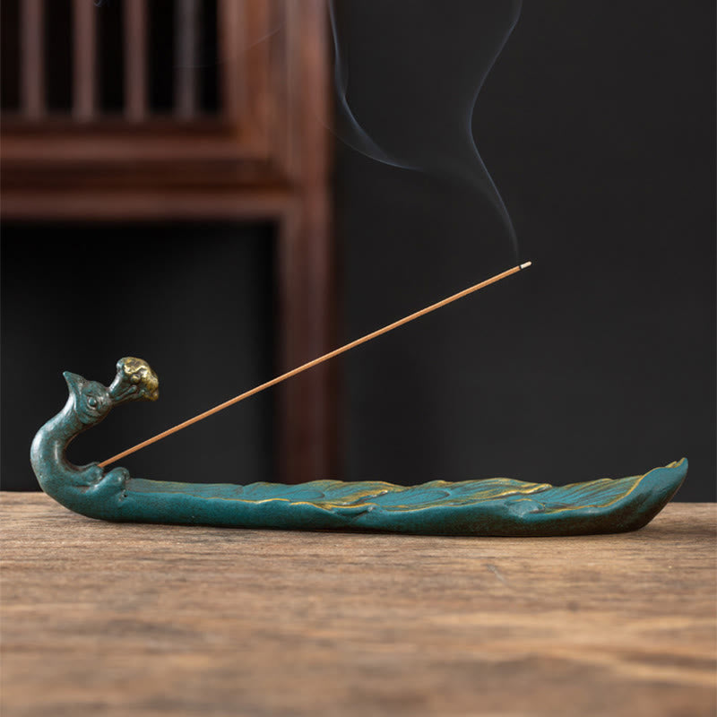 Peacock Shape Ceramic Incense Burner – Teal and gold lotus leaf peacock holder with burning incense, dark background, ceramic incense holder