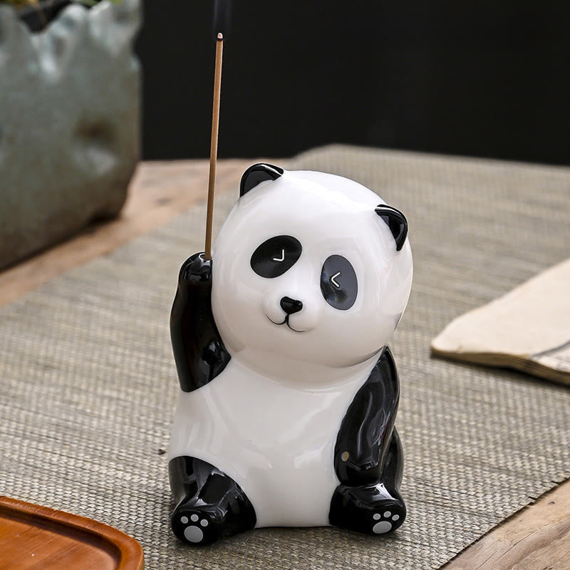 Panda Ceramic Incense Burner - Panda with sparkle eyes holding incense on dark mat, zen decor