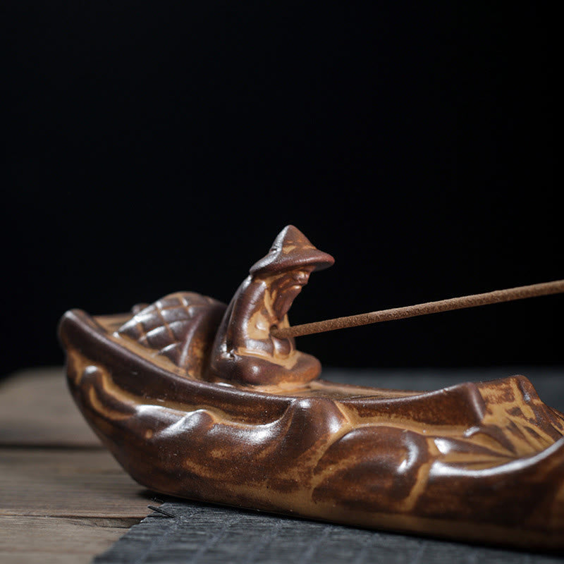 Boat Cicada Ceramic Incense Burner – Side profile of ceramic boat with fisherman on black background, artisan