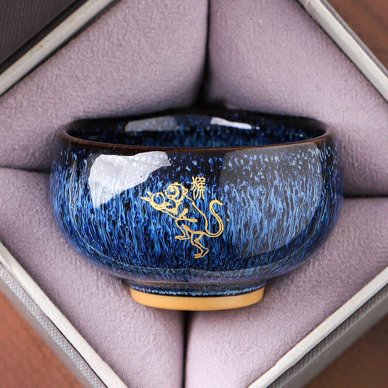 Ceramic Horse Zodiac Cup – Gold monkey on blue streaked glaze, overhead view, witty