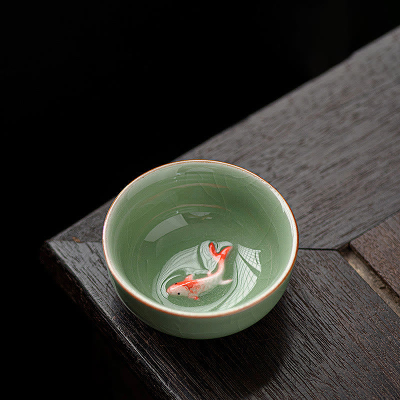 Hand Painted Koi Fish Ceramic Teacup – overhead view of orange koi and water ripples inside celadon cup