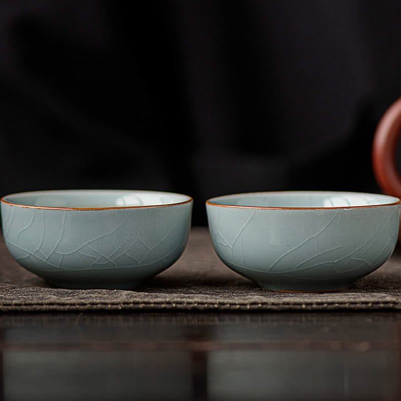 Hand Painted Koi Fish Ceramic Teacup – pair of crackle glaze cups on textured mat, traditional gongfu ware