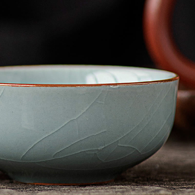 Hand Painted Koi Fish Ceramic Teacup – side profile showing celadon crackle glaze and rust rim, artisan cup